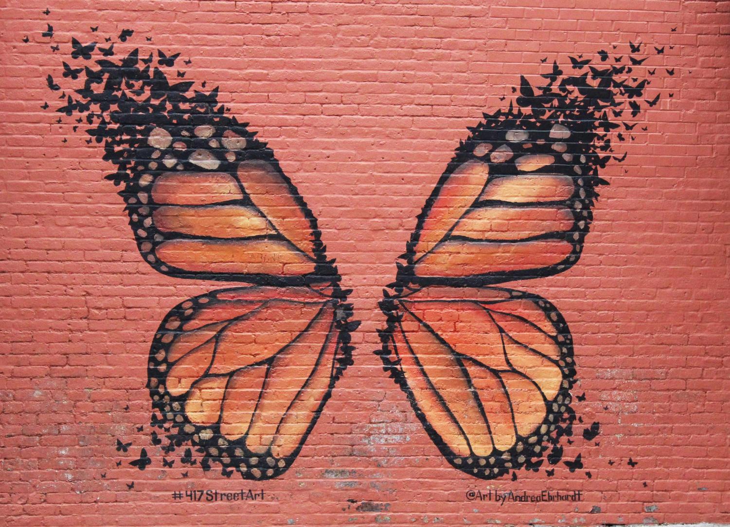 A beautiful butterfly that is painted on a brick wall in the center of downtown Springfield.