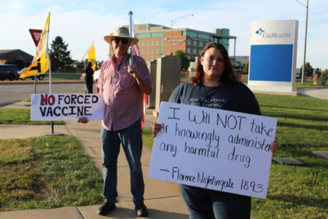 Unnamed protesters stand outside the Cox hospitals protesting the vaccine mandate for employees.