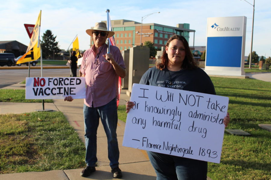 Unnamed protesters stand outside the Cox hospitals protesting the vaccine mandate for employees.