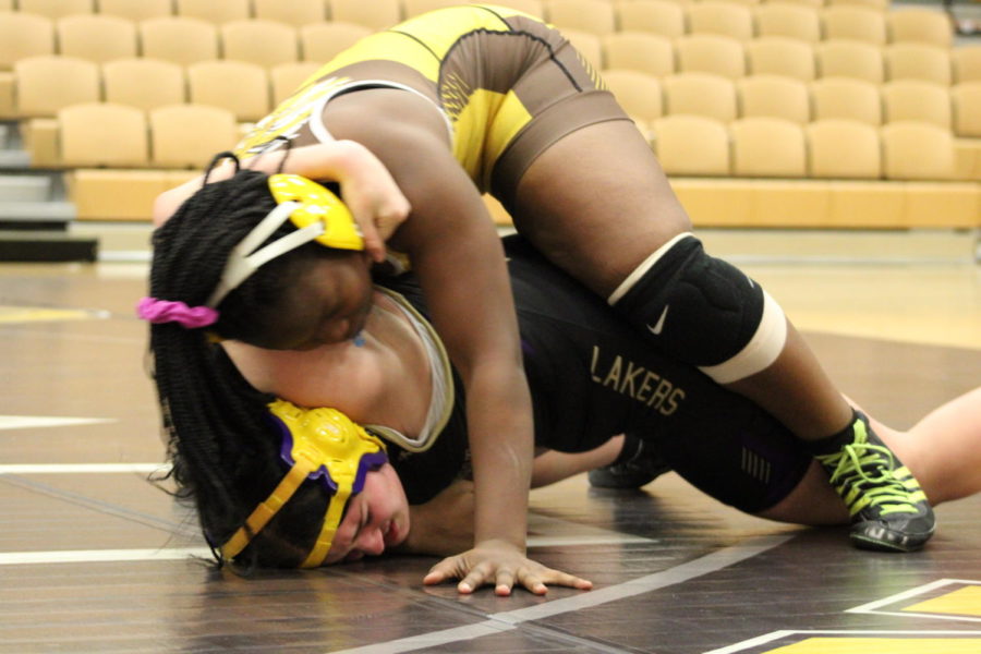 Riley-Washington attempts to pin her opponent to the mat for the win. 
