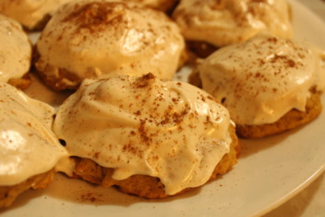 Pumpkin cookies with cream cheese frosting and cinnamon sprinkled on top. 
