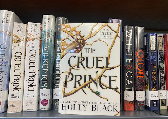 The Cruel Prince with Holly Blacks other novels in the background. 