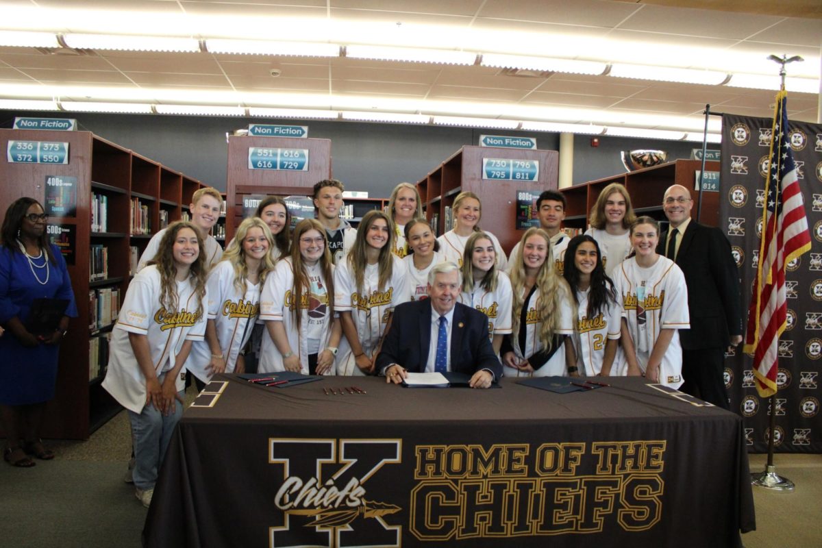 Governor Parsons signing the House Bill 2 in our library, surrounded by Cabinet members and Dr. Powers. 