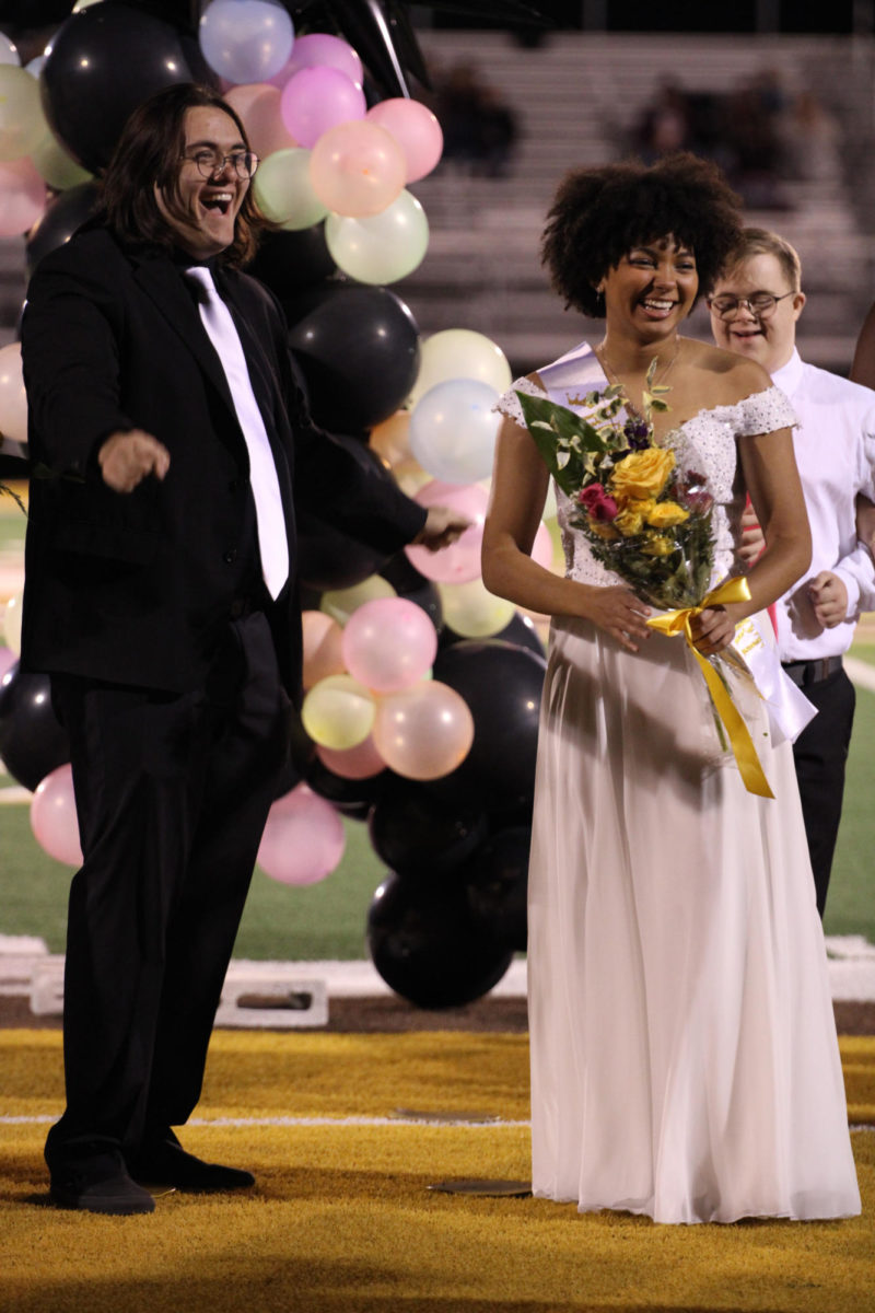 Senior homecoming queen Catelyn Conover laughing with her escort, senior Cole Dobbs.