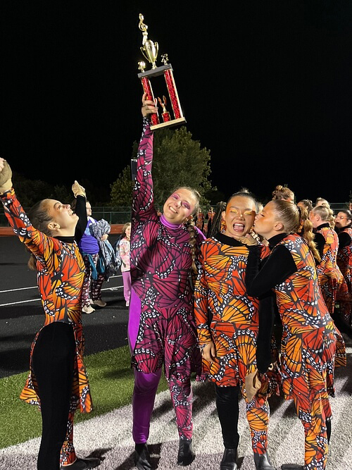 Color Guard showing off their first place trophy after a long day of competition in Ozark, Missouri.
