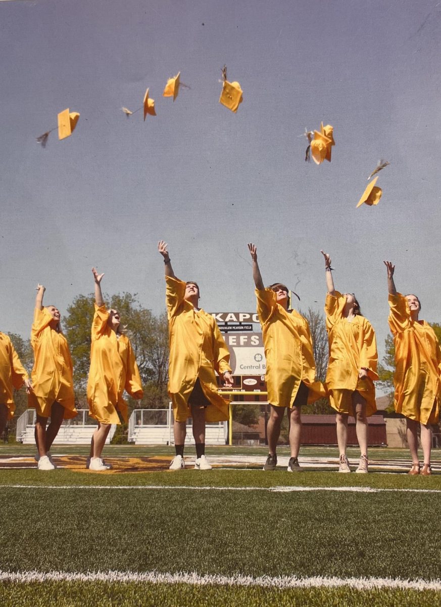 2023 seniors toss their graduation caps in the air as they prepare to embark on a new part of their life. This photo was also used as the back cover photo of 2023 fourth quarter KHQ magazine.