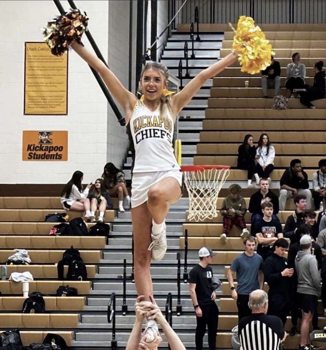 Kate Black being stunted by her teammates at a basketball game.
