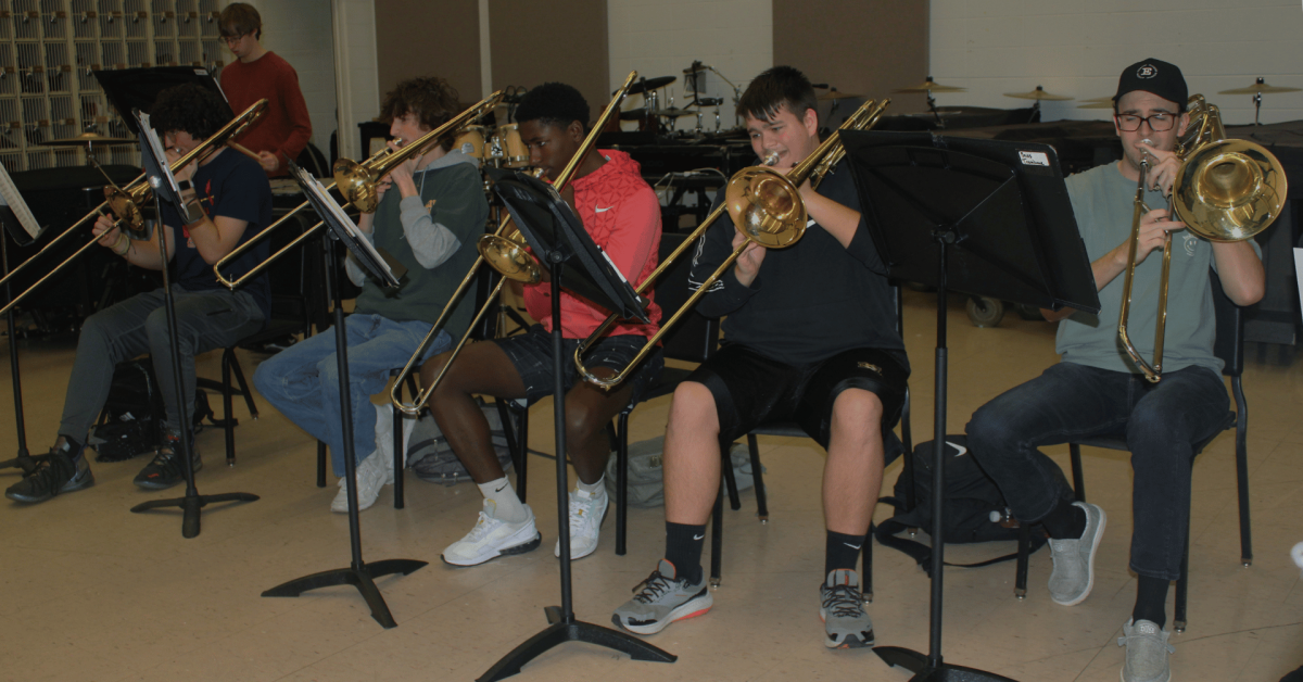 The trombone section is practicing a piece of music that was performed at the band concert on March 5th.